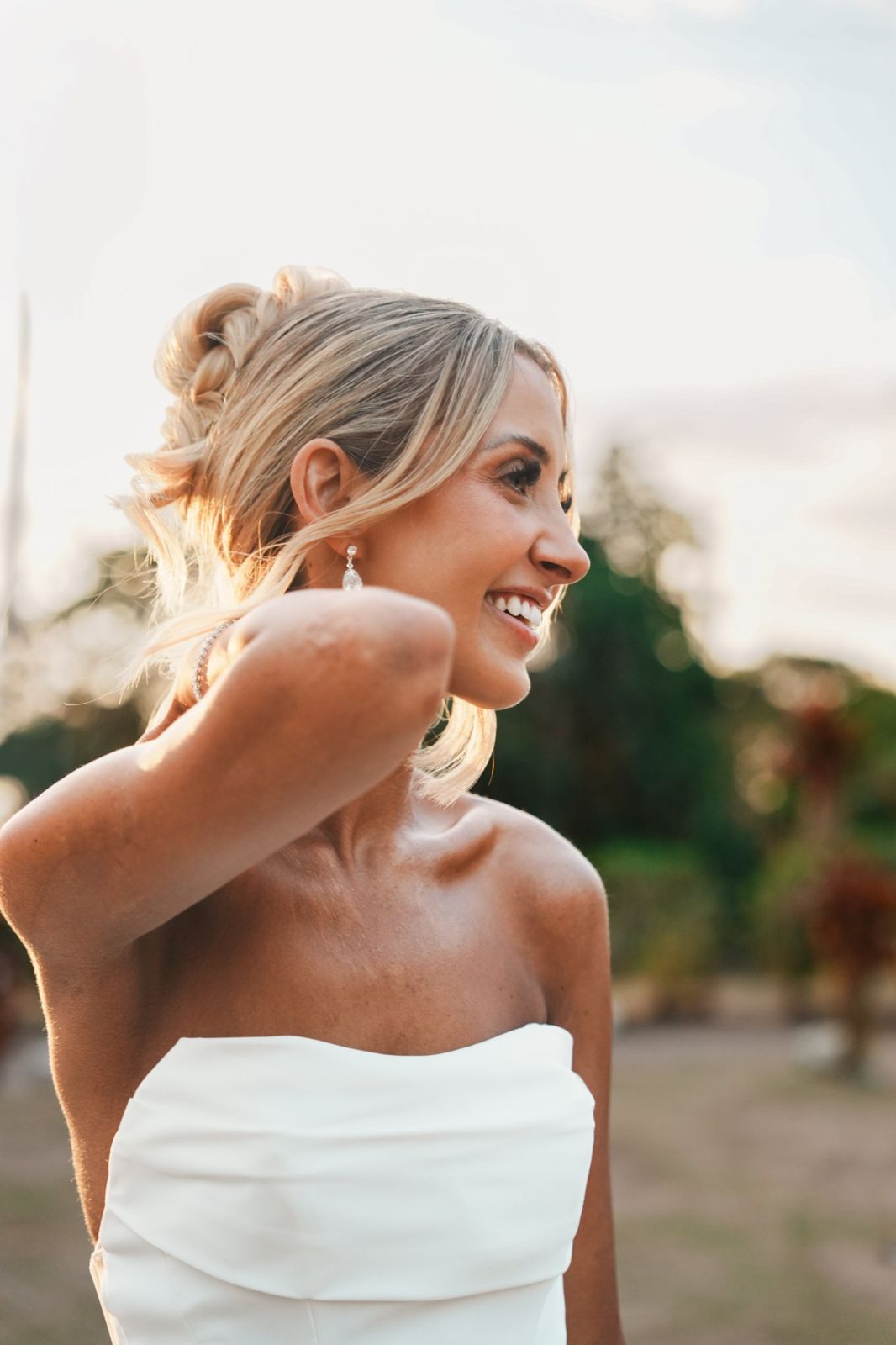 Bride smiling in profile in warm evening light